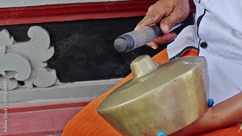 Close-Up of a Traditional Balinese Gamelan Musician Playing a Brass Gong Kettle