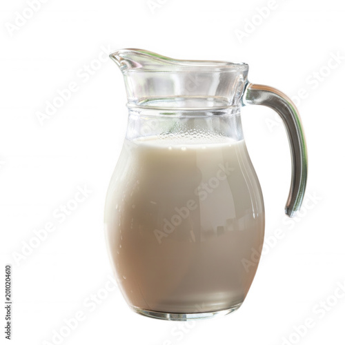 A clear glass pitcher filled with fresh white milk, isolated against a solid black background, showing condensation droplets on the surface