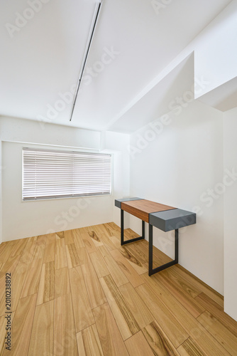 Bright minimalist white room with wooden floor and natural light