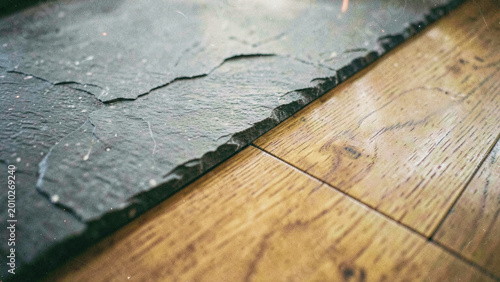 Rustic texture contrast of dark slate and natural wood surface