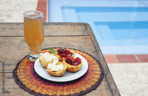 Tropical Appetizers and Cold Beer Served on a Table by the Pool