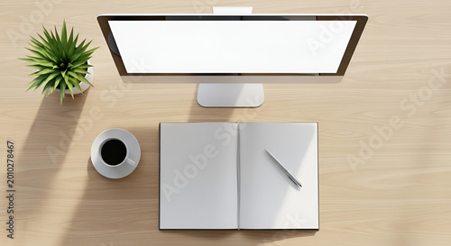 overhead view of a modern workspace with computer and notebook on wooden desk