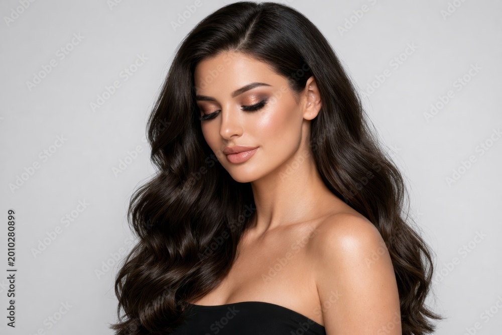 Fototapeta premium Elegant woman with long wavy hair posing on grey background.. Ai generative