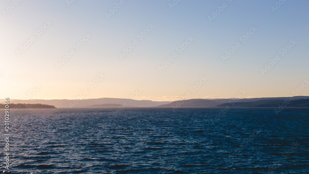 Fototapeta premium Sailing out of Oslofjord approaching Golden Hour, Oslo, Norway, April 2026
