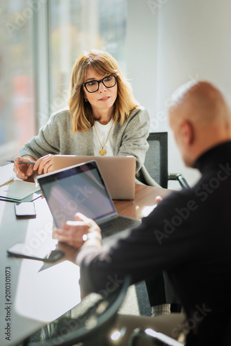 Group of business people having business meeting in a bright conference room