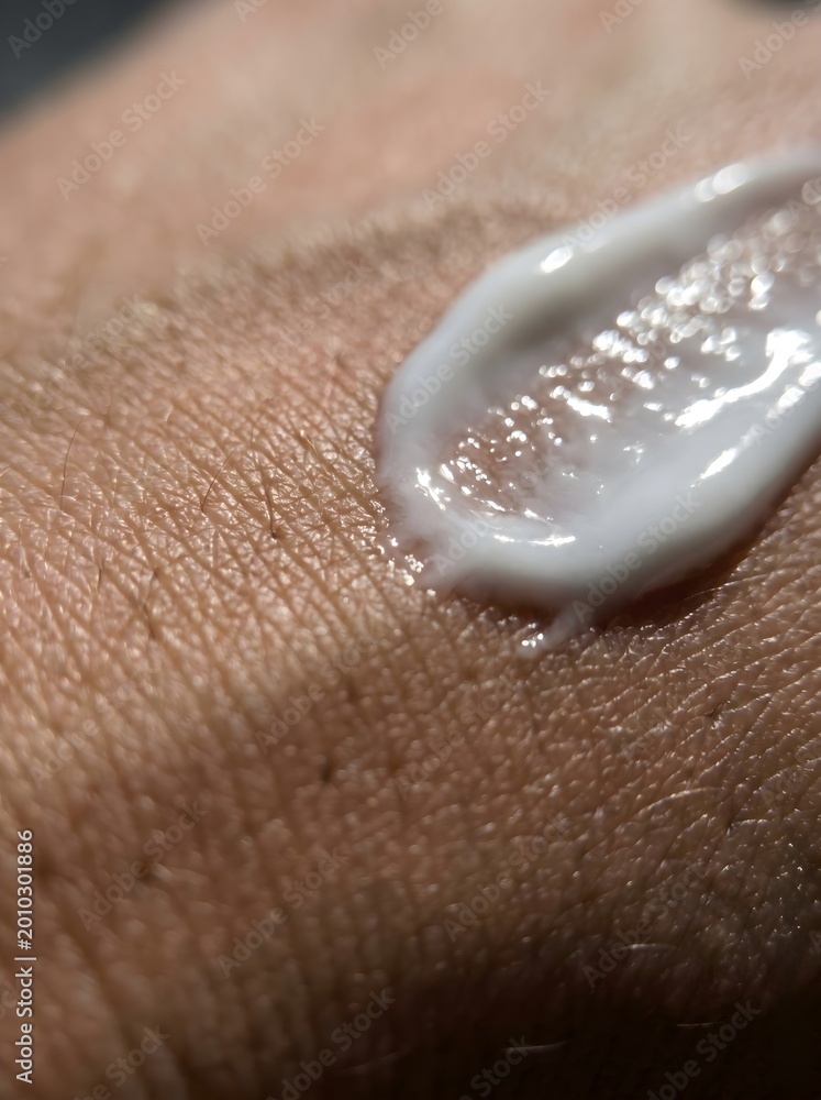 Fototapeta premium Extreme macro detail of mosquito repellent lotion applied on hand