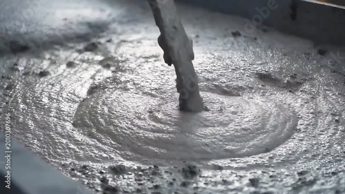 Close up of wet concrete being poured at a construction site