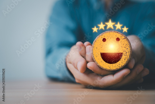 Customer satisfaction concept with smiling face and five star rating in hands, represent positive feedback, service quality, user experience, business trust, review system and client happiness