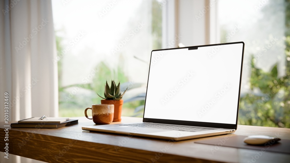 Naklejka premium Laptop Blank Screen Mockup on Desk in Bright Modern Home Office - Angled View