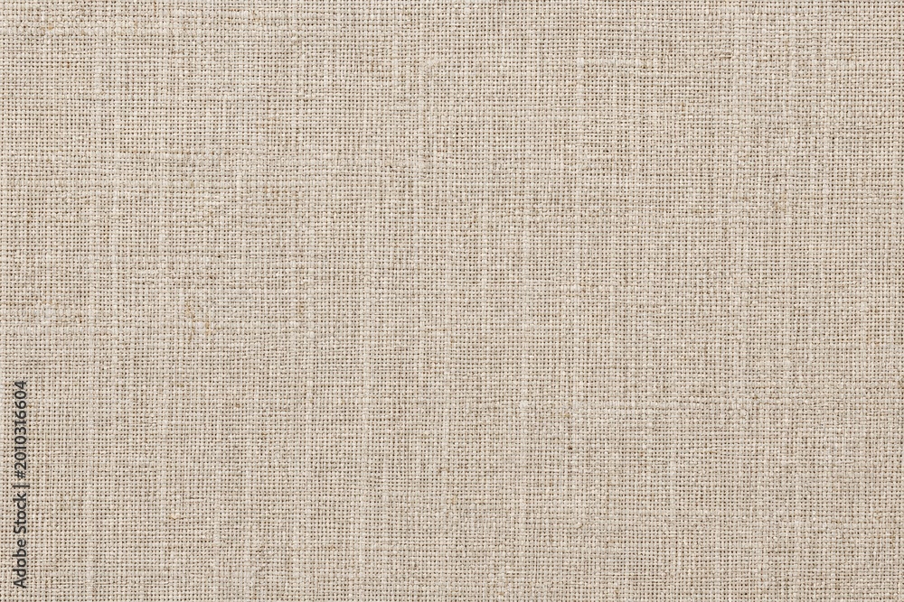 Fototapeta premium Close-up of intricately woven beige linen fabric with subtle diagonal texture lines, natural light highlighting the fine threads, minimalist and elegant textile background for fashion, design, or