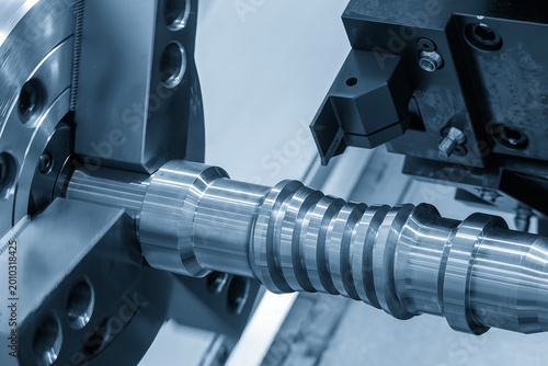 High precision production process of a lead ball screw shaft using a CNC lathe machine in a blue-toned industrial scene.