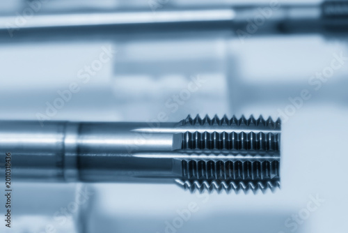 Photography High-precision metal tapping tool for internal thread cutting in a horizontal blue-toned scene