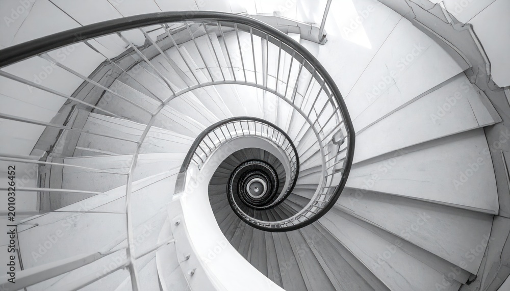 Fototapeta premium Overhead view of a spiraling staircase, monochrome