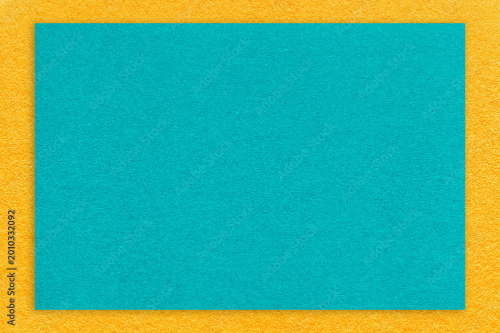 Fototapeta premium Texture craft turquoise paper background with yellow border, macro. Structure vintage cerulean cardboard