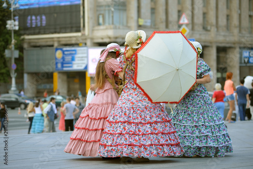 Bild auf Leinwand Women in vintage dresses and straw hats acting as sweets vendors on Maidan Nezal