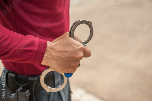Fotografija Police demonstrate how to use handcuffs to restrain suspects or prisoners