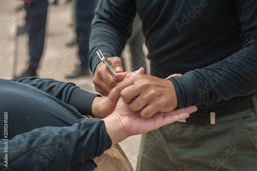 Tableau sur toile Police demonstrate how to use handcuffs to restrain suspects or prisoners