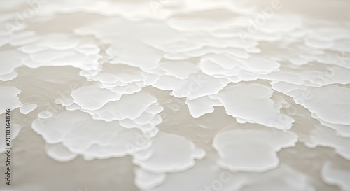 Closeup of melting white frost on a surface in warm light