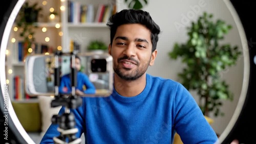 South Asian Influencer Waving And Talking To Camera With Professional Ring Light Setup In Home Office Studio