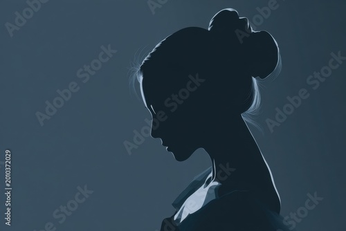 Woman silhouette side profile with elegant bun on dark blue