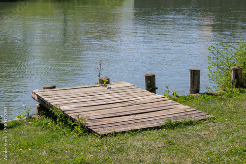 Canvastavla Old wooden pier planks over calm river water