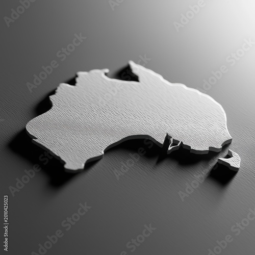 Detailed silver three dimensional silhouette of the Australian continent resting on a dark textured smooth surface