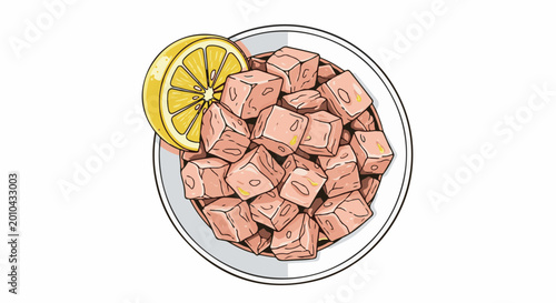 A dish of diced tuna with a slice of lemon