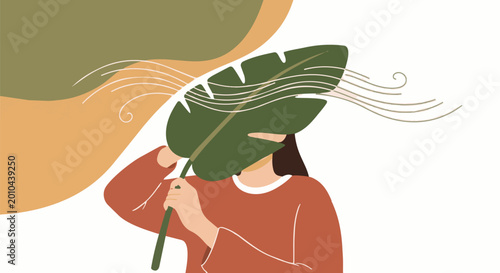 Tableau sur toile Woman Holding Large Leaf Shielding Face From Wind.