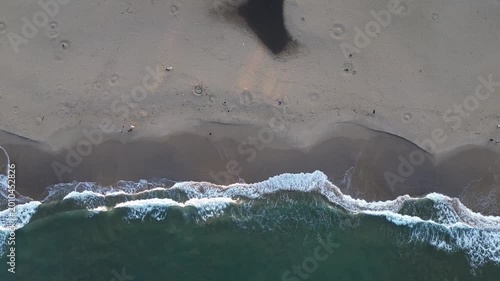 Beautiful Aerial View of Ocean Waves Crashing on Sandy Shore