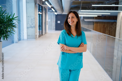 Female medical professional standing in modern hospital corridor