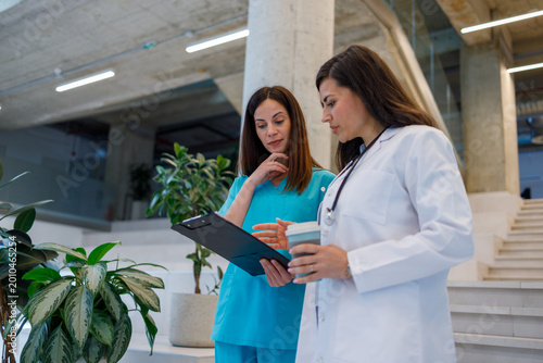 Medical professionals collaborating during hospital corridor discussion