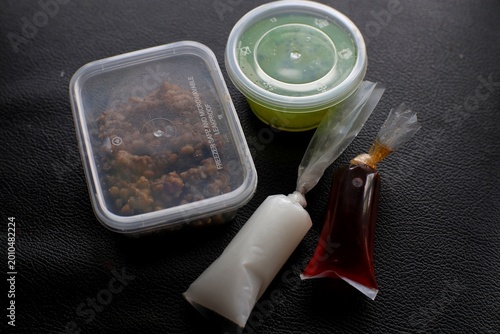 Fotografía Assortment of condiments and sauces in plastic containers