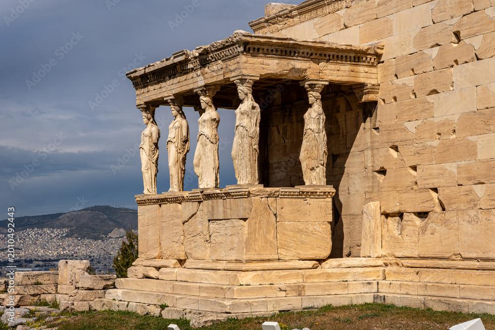 Fototapeta premium A detailed view of the iconic Porch of the Maidens (Caryatids) at the Erechtheion temple on the Acropolis of Athens, Greece. The six female statues serve as architectural columns supporting the roof, 