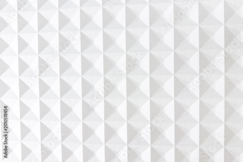 White seamless abstract background with repeating geometric pyramid shapes forming a textured surface