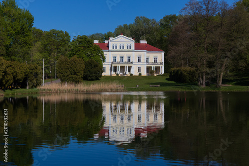 Raczynski Palace reflected in the Irydion pond, Zloty Potok, Jura Krakowsko-Czestochowska, Poland.