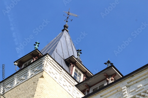 Doles Manor House, Latvia. Historic manor roof detail on a sunny day. Warm sunlight highlights aged roof tiles and traditional architecture, showcasing heritage, texture, and timeless European country