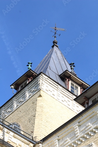 Doles Manor House, Latvia. Historic manor roof detail on a sunny day. Warm sunlight highlights aged roof tiles and traditional architecture, showcasing heritage, texture, and timeless European country