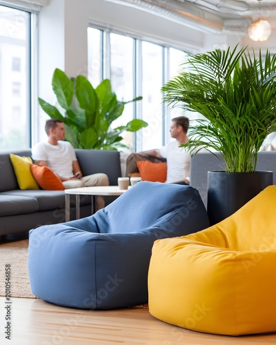 Two people in a lounge area talk while sitting on comfortable seating