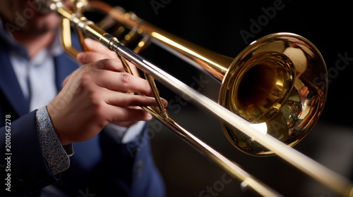 gleaming brass trombone during a lively musical performance, copy space closeup