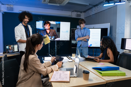 Photos Diverse creative team having a hybrid meeting in office room