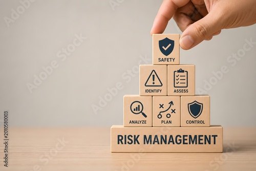 Hand Placing Safety Block on Top of Risk Management Pyramid for Business Security and Assessment Concept