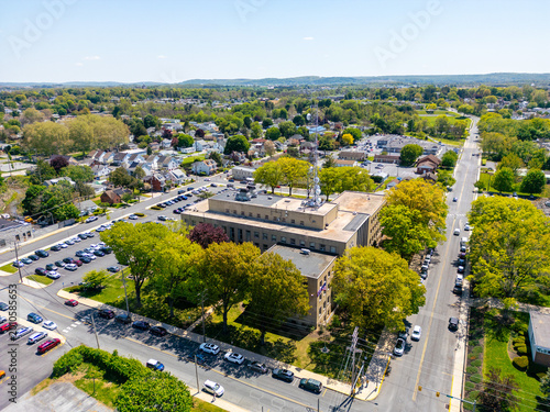 Aerial view of a modern municipal government building and courthouse complex in a small city.