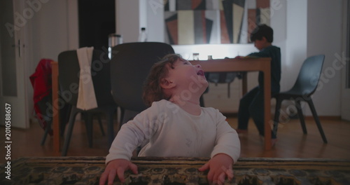 Cuadro en lienzo Toddler losing balance while letting go of table support and falling on floor, i