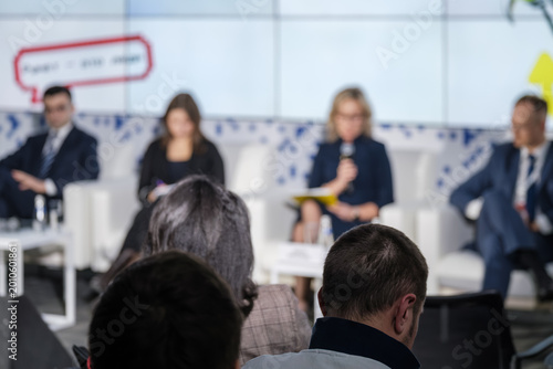 фотографія Audience watches panel discussion at corporate conference, speakers on stage, professional networking and business presentation