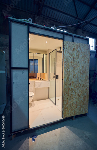 Prefabricated modular bathroom pod units in a factory with plumbing, sink, shower, bath and electrics installed ready for hotel and high rise apartment construction