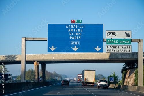 View of a French and European autoroute with overhead directional signs pointing to major cities like Paris, Bordeaux, Lille, Calais, showing lanes, traffic and motorway infrastructure, road signes