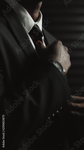 Hands, assassin and suit with getting ready for secret mission, espionage and danger at office. Person, government agent or tie for fashion on undercover assignment, career or hitman with clothes