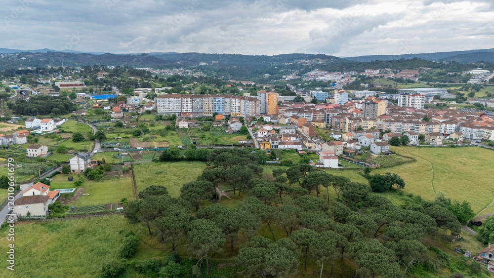 Fototapeta premium Ourense cityscape blending with rural green landscape
