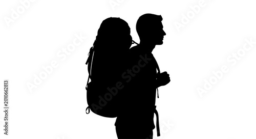 Photos Silhouette of a male backpacker hiking in profile.