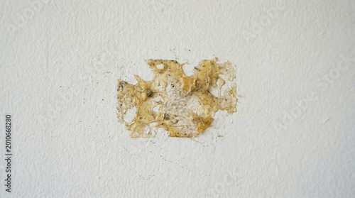 Wall with tape residue showing damage on white surface  